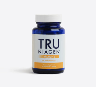 A blue bottle of Tru Niagen Immune supplements with a white and orange label.